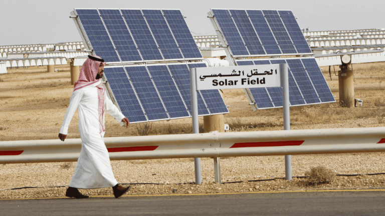 A Saudi Man Walks Past Solar Power Plant Project in Middle East. (Reuters)